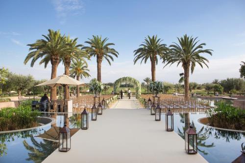 a wedding aisle at a resort with palm trees at Fairmont Royal Palm Marrakech in Marrakech