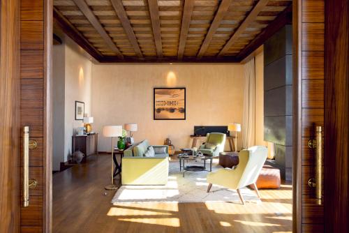 a living room with a couch and a table and chairs at Fairmont Royal Palm Marrakech in Marrakech