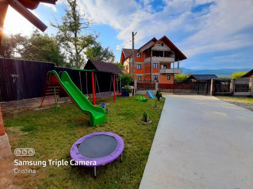 a playground with a slide and a slide at Casa Trache in Călimăneşti