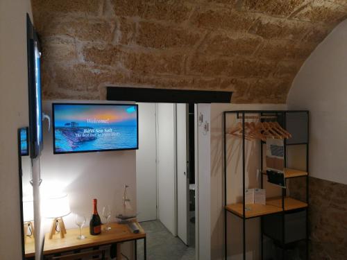 a living room with a tv on the wall at B&B Sea Salt in Terrasini