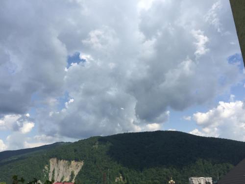 a view of a mountain under a cloudy sky at Guest House Arnika in Yaremche
