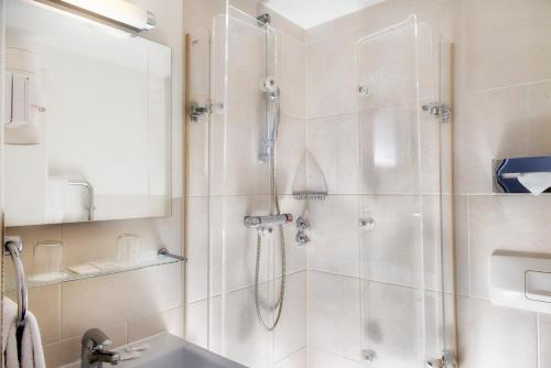a bathroom with a shower and a sink at Park Hotel am Berliner Tor in Hamburg