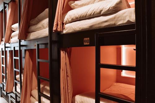 a bed room with two bunk beds and a window at Durty Nelly's Inn in Amsterdam