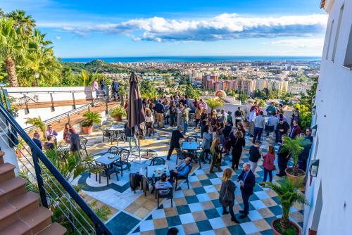 a crowd of people standing on the roof of a building at Villa Guadalupe in Málaga