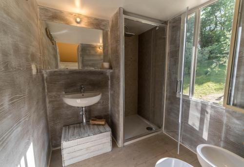 a bathroom with a sink and a shower at Glamping in Toscana, luxury tents in agriturismo biologico in Sorano