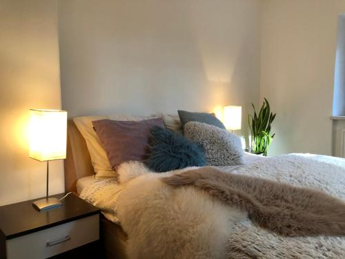 a bedroom with a bed with pillows and two lamps at Vila Anton in Karlovy Vary