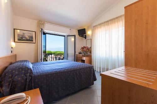 Postel nebo postele na pokoji v ubytování Hotel Fortunella