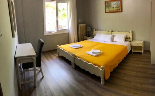 a bedroom with a bed and a table and a desk at Captain Michalis house in Parga