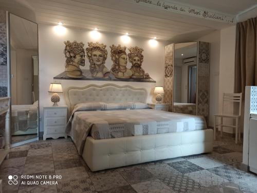 a bedroom with a bed, a dresser and a fireplace at B&B Triskèles in Giardini Naxos
