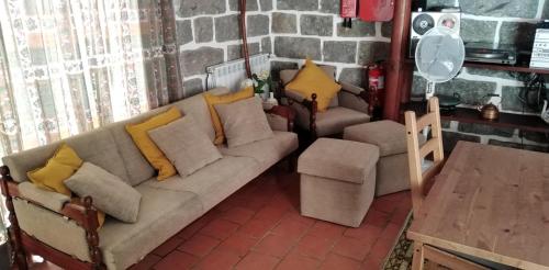 a living room with a couch and two chairs at Casa do Avô Xico - Gerês Lake House - 10pax in Geres