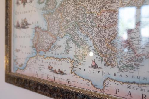 a map of the middle east in a gold frame at Amalfi Old Square room & apartments , 73 steps from the street in Amalfi
