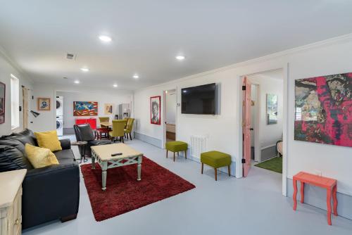 a living room with a couch and a table at Folly Vacation Laid Back Casual Beach Bungalow 209-B in Folly Beach