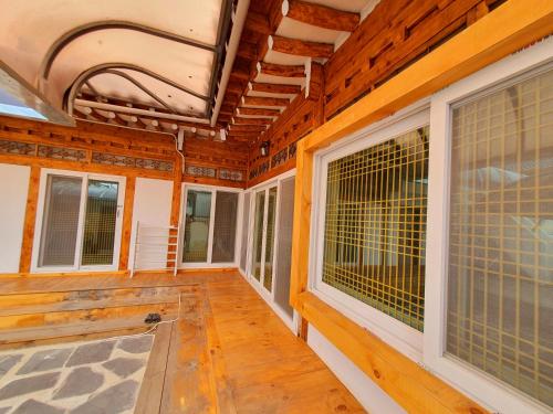 a porch of a wooden house with large windows at Hwangridangil Adamjeong in Gyeongju