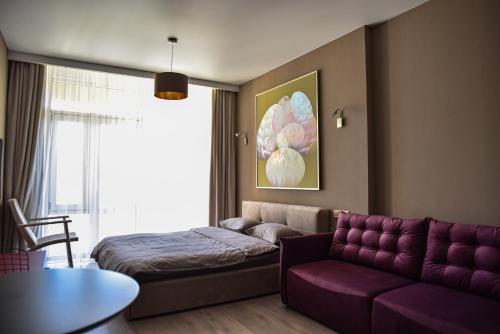 a living room with a couch and a bed at Corner House in Odesa