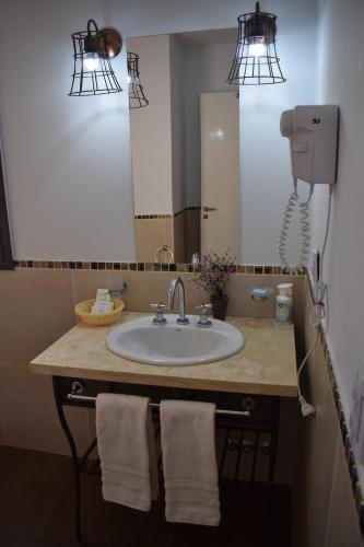 a bathroom with a sink and a mirror at BELLA VISTA - CAFAYATE in Cafayate