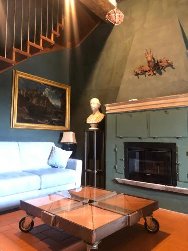 a living room with a couch and a fireplace at Torre Caetani- Night in a medieval tower in Todi