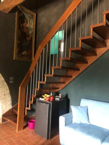 a staircase in a living room with a white couch at Torre Caetani- Night in a medieval tower in Todi