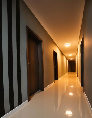 a hallway with black and white walls and white tile floors at Resita Residence in Reşiţa