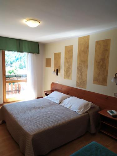 Postelja oz. postelje v sobi nastanitve Albergo Ristorante Cacciatori