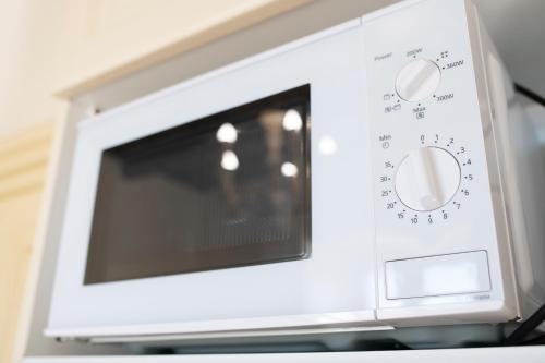 a microwave oven sitting on top of a counter at Amalfi Old Square room & apartments , 73 steps from the street in Amalfi