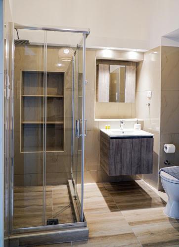 a bathroom with a shower and a sink at Smyrnis Apartments in Ermoupoli