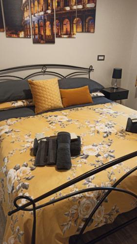 a bed with a yellow and white comforter at Affittacamere da Barby in Rome