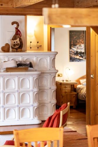 a bedroom with a bed and a table and chairs at Appartamento Casa Brigadoi in Predazzo