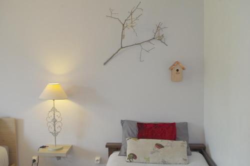 a bedroom with a bed and a bird house on the wall at Les 4 saisons in Graye-sur-Mer