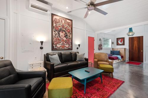 a living room with a couch and a table at Folly Vacation 209 East, Modern, Sassy and 3 Blocks to the Beach in Folly Beach