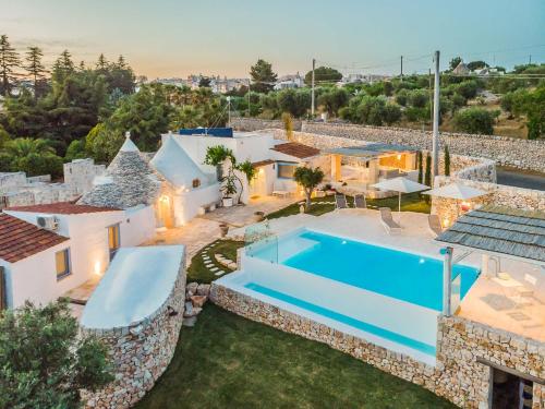 an image of a villa with a swimming pool at Trulli Terra Magica in Putignano