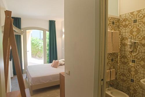a bedroom with a bed and a bathroom at B&B CASA GIOVANNA in Campese