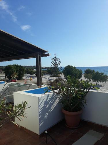 a balcony with a view of the beach at Katerina & Efi Apartments in Mastichari