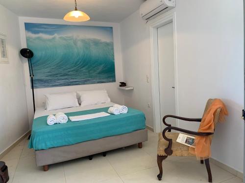 Un dormitorio con una cama con un cuadro en la pared. en Attik Residencies, en Livadi