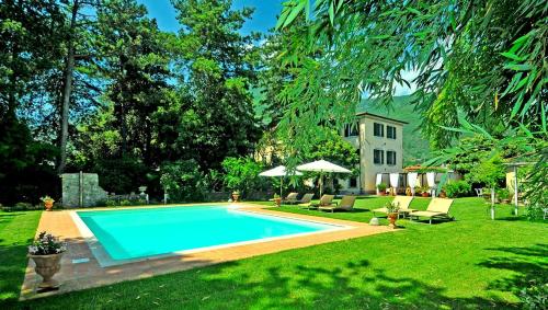 a swimming pool in the yard of a house at Villa Lombardi in Camaiore