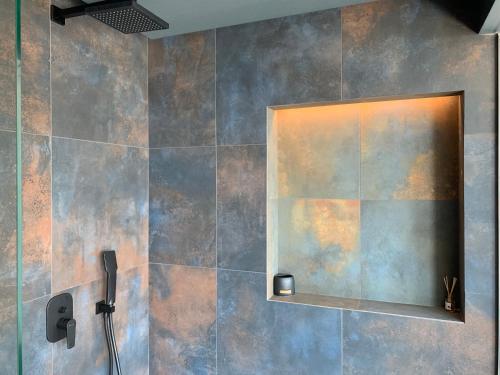 a bathroom with a shower with a mirror at Rokamare Beach Resort in Liapades