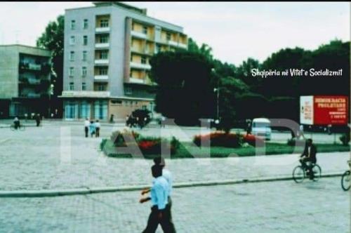 a man walking in a parking lot with a skateboard at Hotel Fieri in Fier