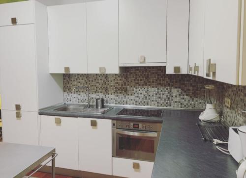 a kitchen with white cabinets and a stove at Apartamento de Lujo I en Madrid Centro in Madrid