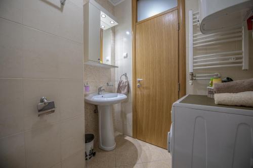 a small bathroom with a sink and a toilet at Stella Modern Apartment 2 in Novi Sad