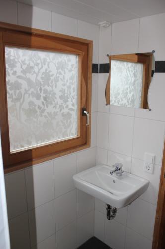 a bathroom with a sink and a window at Ferienhaus am Zainhammer in Brotterode