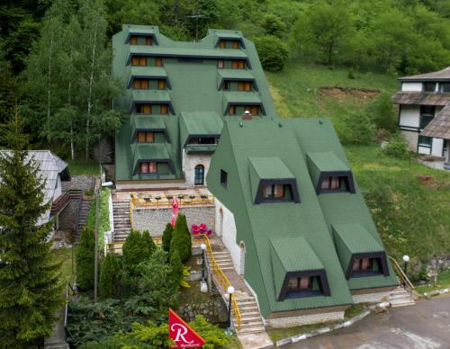 an aerial view of a house with a green roof at Guest House Villa Rankovic in Brzeće