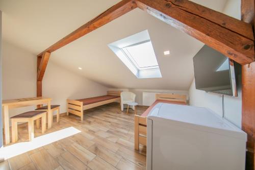 a attic room with a bed and a desk at Na Rybníčku Bohutín in Bohutín