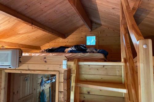 a bedroom in a log cabin with a bed in it at Blockhütte in Rostock Land in Papendorf