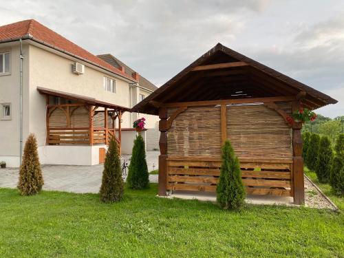 a large wooden garage in front of a house at Absolut Residence Hateg in Haţeg
