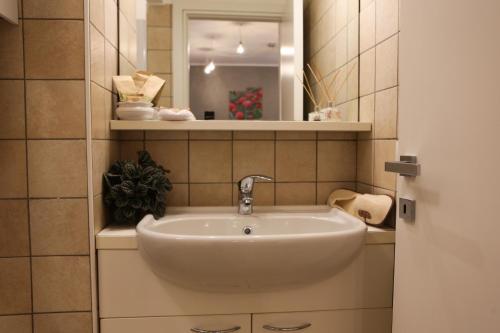 a white sink in a bathroom with a mirror at La casa di Ada in Sondrio