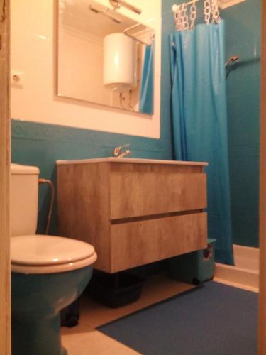 a bathroom with a sink and a toilet and a mirror at Paradis in Morro del Jable