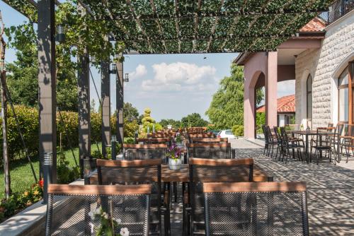 a row of tables and chairs on a patio at Zaara Estate Winery Hotel & SPA in Glavan