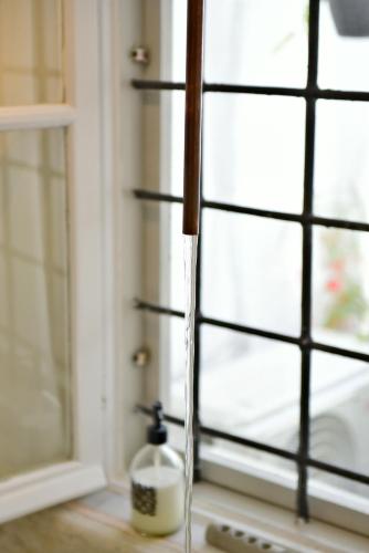 a window sill with a candle on top of a window at Hydra Icons in Hydra
