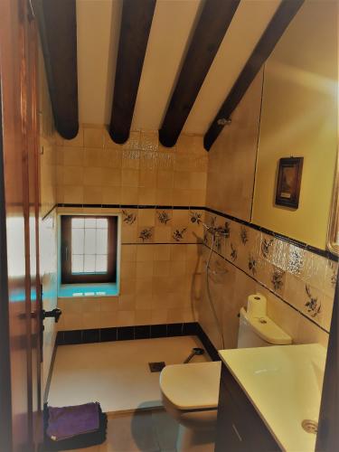 a bathroom with a toilet and a sink at Cortijo Don Enrique in Restábal