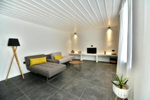 a living room with a couch and a table at Hydra Icons in Hydra
