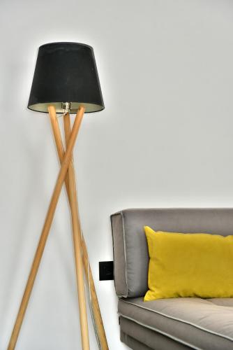 a tripod floor lamp next to a couch at Hydra Icons in Hydra